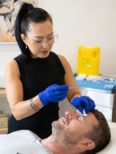 Nurse-Cyndy-treating-patient